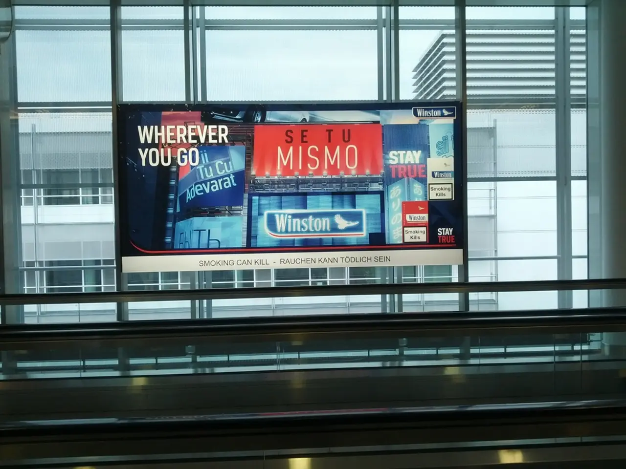 This picture shows a glass window of a building. We see another buildings from the glass and we see...