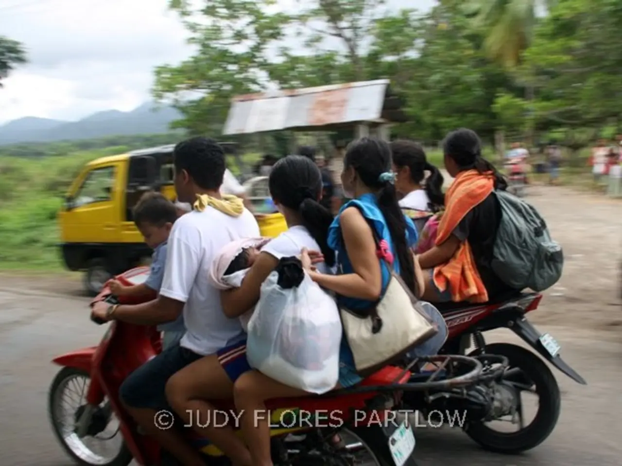Here are few people riding on two motorbikes. This looks like a auto rickshaw. At background I can...