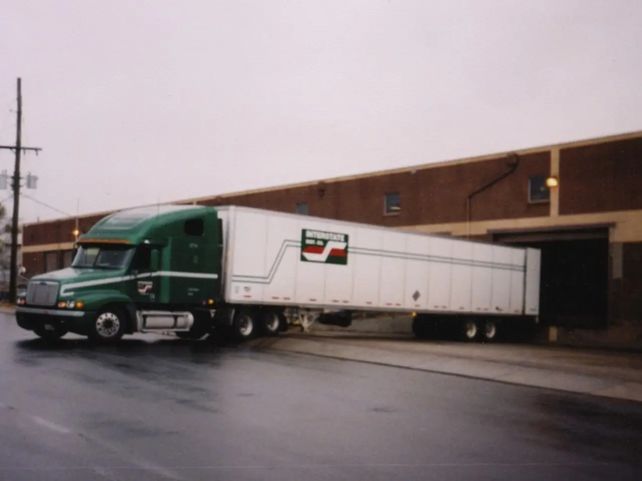 In this picture we can see there is a truck on the path and behind the truck there are trees and an...