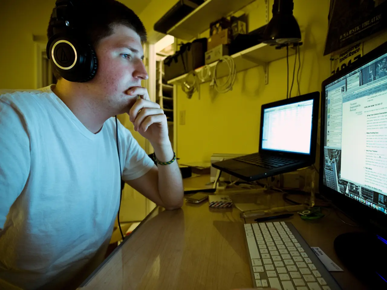 In the image we can see a man wearing clothes and headsets. This is a cable wire, hand band, desk,...