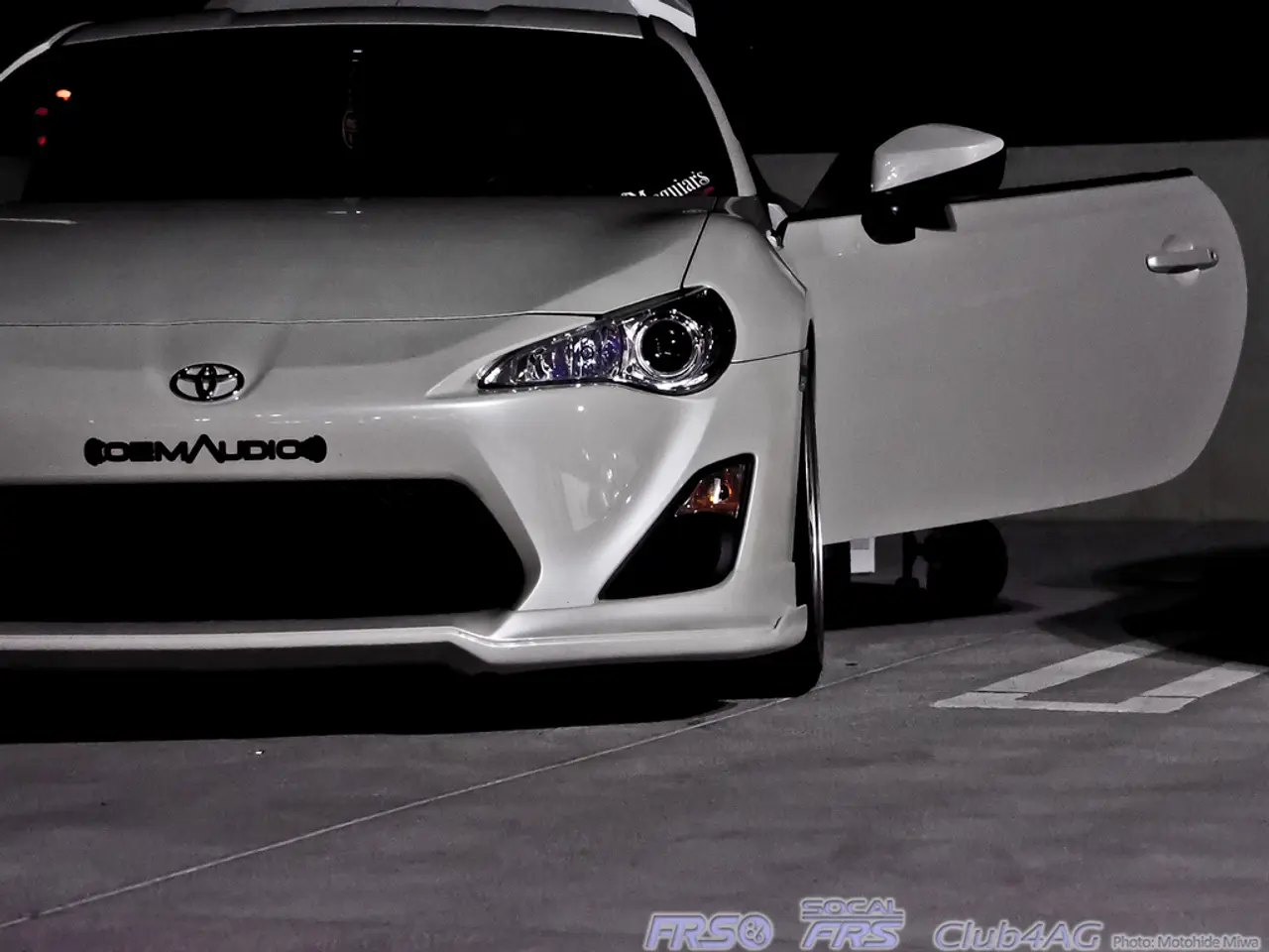 In the image there is a car and the door of the car is opened, there is some text on the bottom...