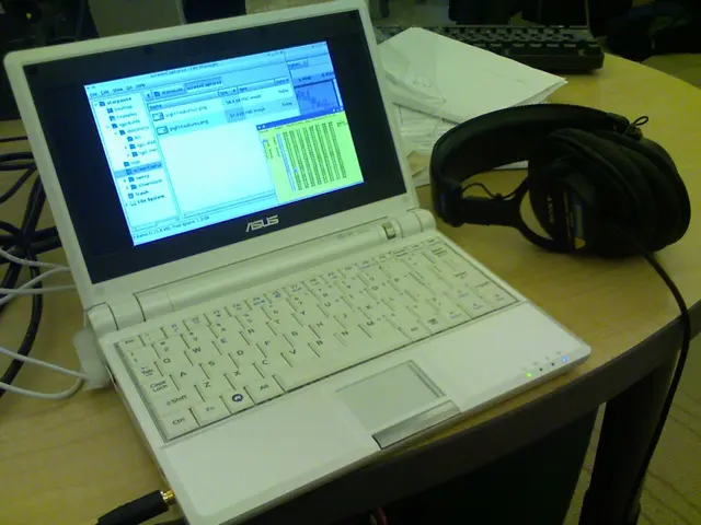 As we can see in the image there is a table. On table there is a keyboard, laptop and headphones.