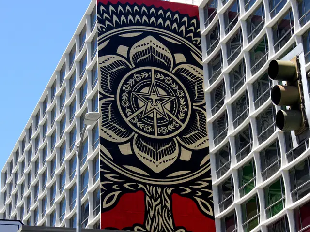 This image consists of a buildings which are on the right side and there is a signal pole. In the...