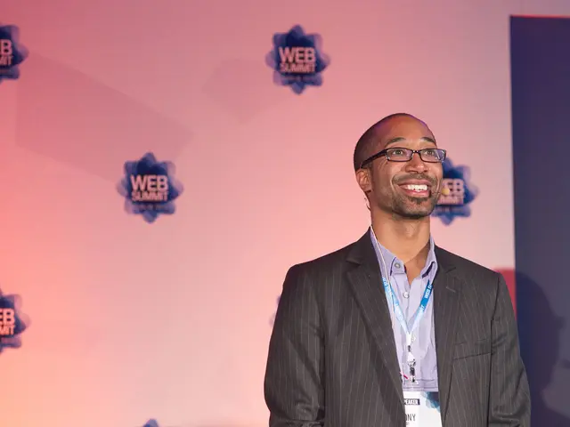 In the center of the image there is a person. In the background we can see advertisement.