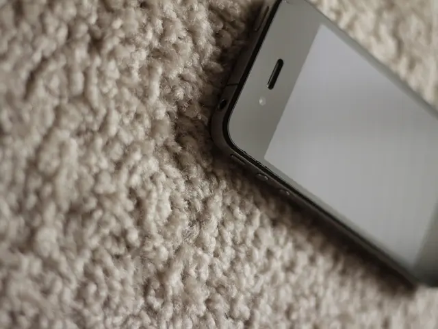 On the right side of the image there is a mobile phone on the mat.