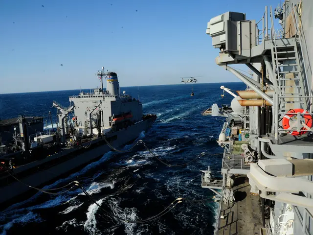 In this image we can see ships on the water. In the background of the image there is a helicopter...