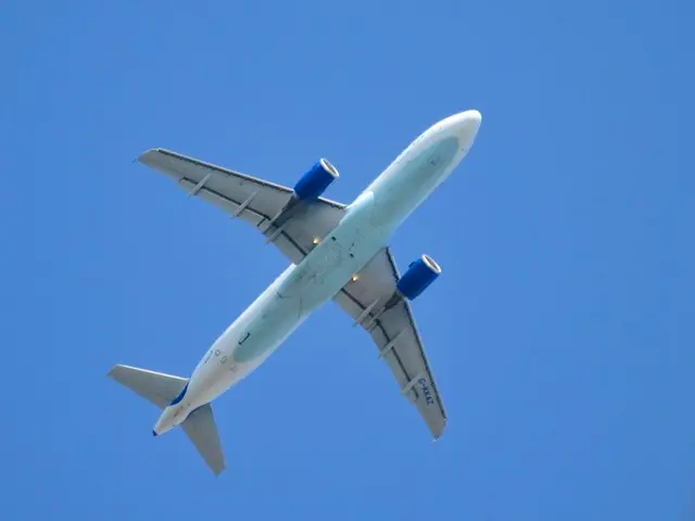 In this image I can see the aircraft flying in the air. It is in white and blue color. Background...