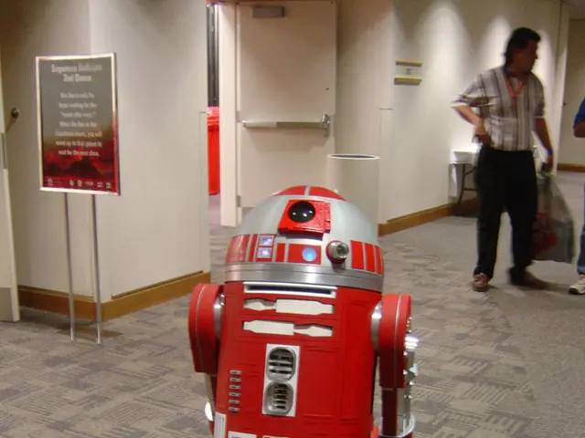 In the foreground of this image, there is a robot on the floor. On the left, there is a board, wall...